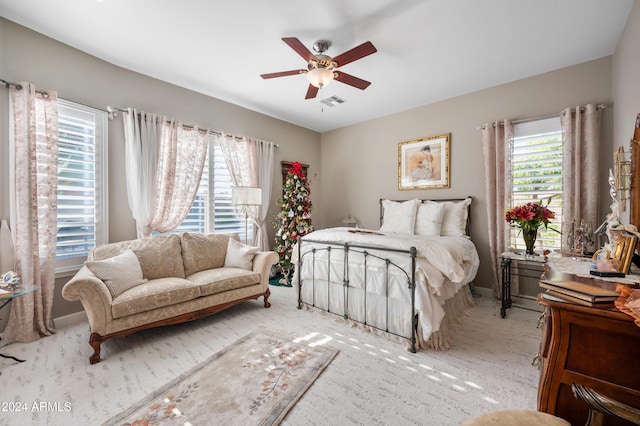 bedroom with ceiling fan and light colored carpet