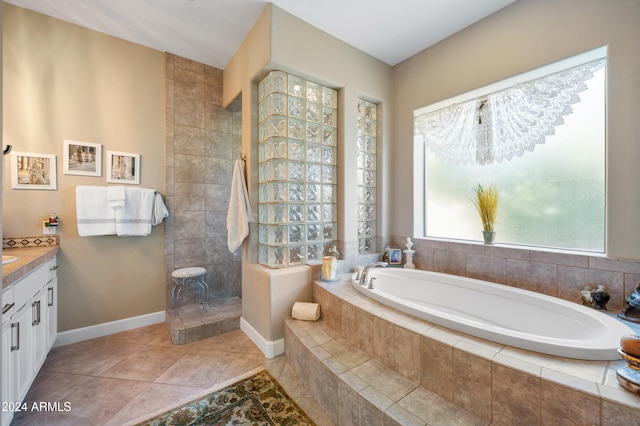 bathroom featuring tile patterned floors, vanity, shower with separate bathtub, and a chandelier