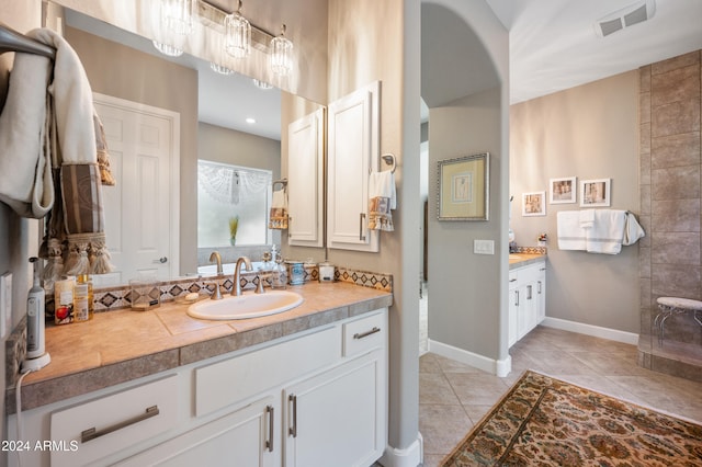 bathroom with tile patterned floors and vanity