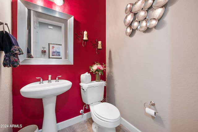 bathroom featuring tile patterned floors, toilet, and sink