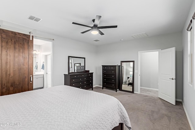 bedroom with carpet floors, baseboards, ensuite bathroom, and a ceiling fan