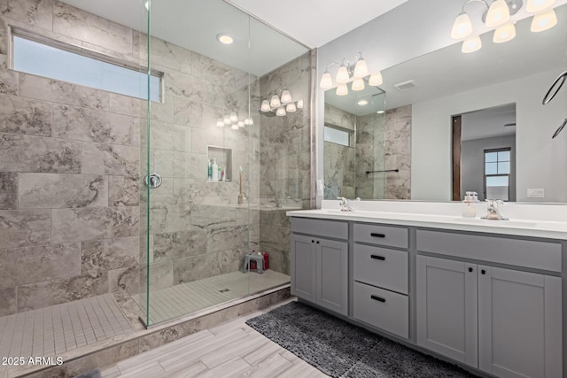 full bath with a shower stall and double vanity
