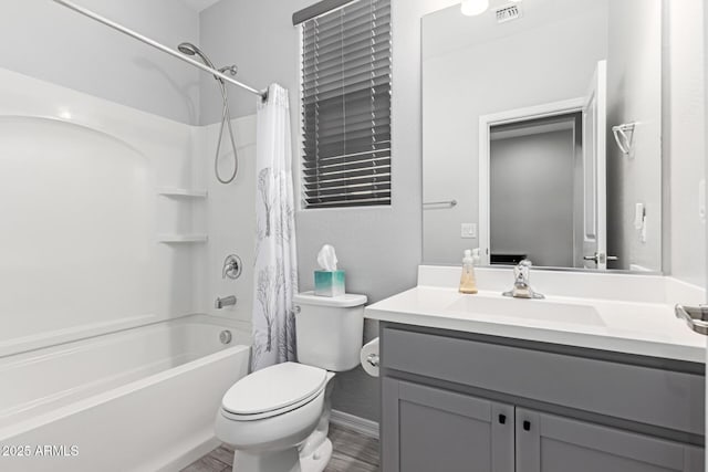 full bath featuring shower / bath combo with shower curtain, vanity, and toilet