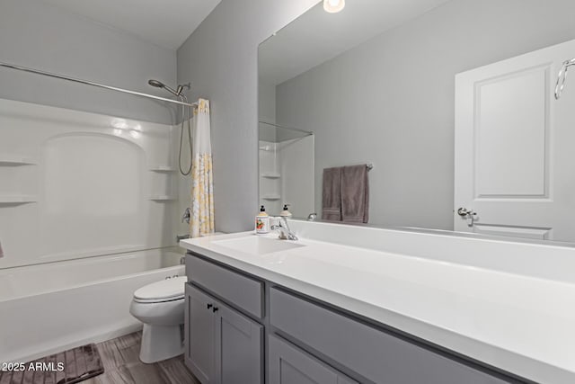 full bath featuring toilet, bathtub / shower combination, and vanity