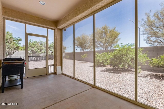unfurnished sunroom featuring finished concrete flooring