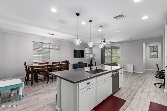 kitchen with a sink, recessed lighting, open floor plan, light wood-style flooring, and an island with sink