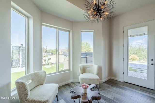 17324 E Quail Track Rd, Rio Verde, AZ 85263 - living area featuring baseboards, wood finished floors, and an inviting chandelier