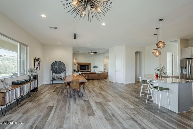 17324 E Quail Track Rd, Rio Verde, AZ 85263 - living area with visible vents, light wood-style floors, arched walkways, and recessed lighting