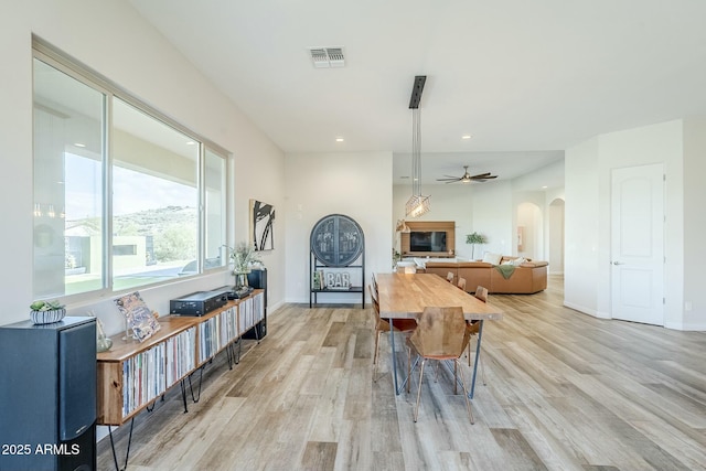 17324 E Quail Track Rd, Rio Verde, AZ 85263 - interior space featuring a ceiling fan, light wood-style flooring, baseboards, visible vents, and arched walkways