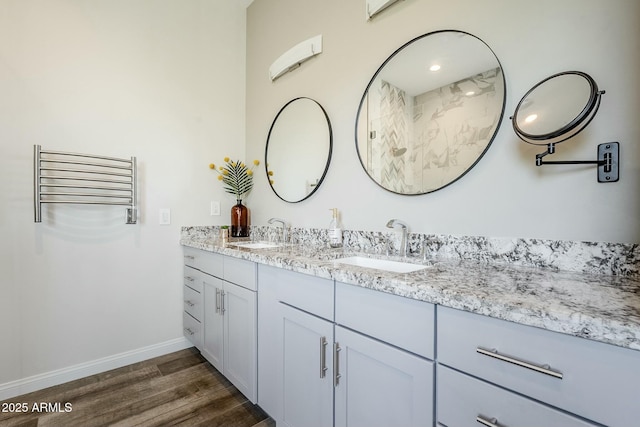 17324 E Quail Track Rd, Rio Verde, AZ 85263 - full bathroom with baseboards, double vanity, a sink, and wood finished floors