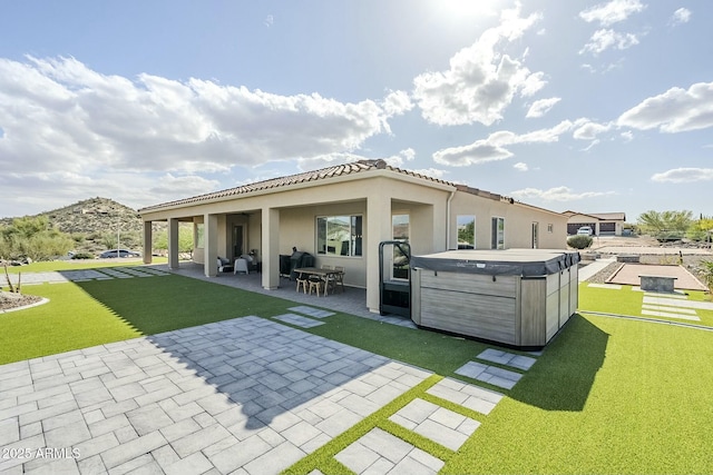 17324 E Quail Track Rd, Rio Verde, AZ 85263 - back of house with a lawn, stucco siding, a patio, and a hot tub