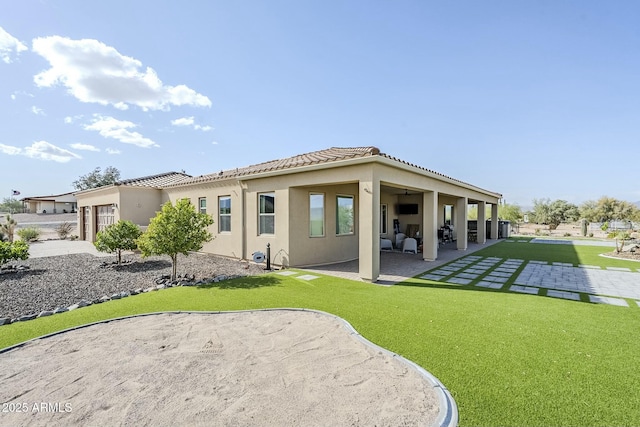 17324 E Quail Track Rd, Rio Verde, AZ 85263 - rear view of house with a tile roof, a patio area, stucco siding, an attached garage, and a yard