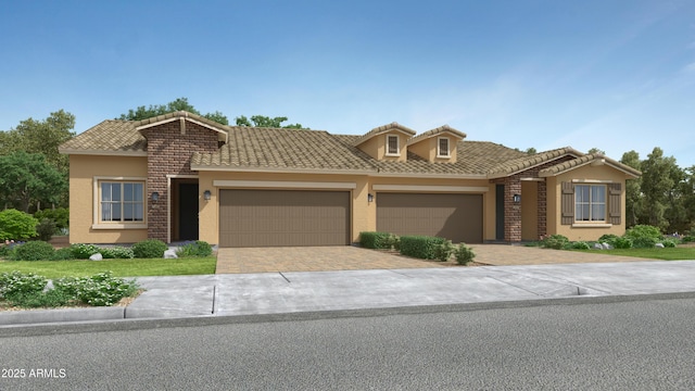 view of front of property featuring a garage, driveway, a tiled roof, and stucco siding