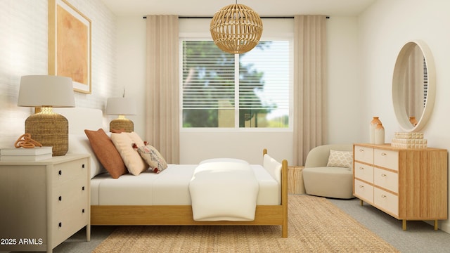 bedroom featuring an inviting chandelier and light colored carpet