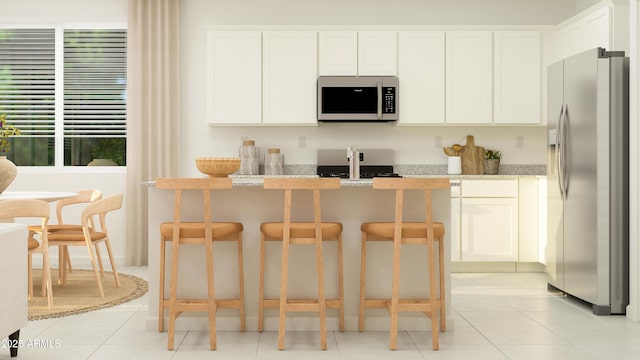 kitchen with stainless steel refrigerator with ice dispenser, light tile patterned flooring, and white cabinetry