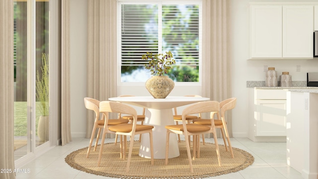 dining room featuring a healthy amount of sunlight, baseboards, and light tile patterned floors