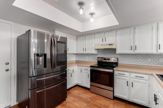 kitchen featuring stainless steel appliances, custom exhaust hood, and white cabinetry