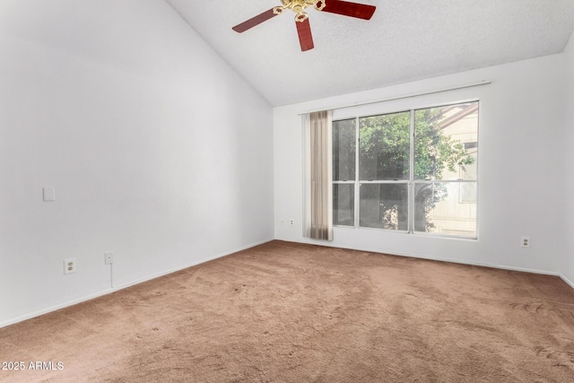 empty room featuring lofted ceiling, ceiling fan, and carpet