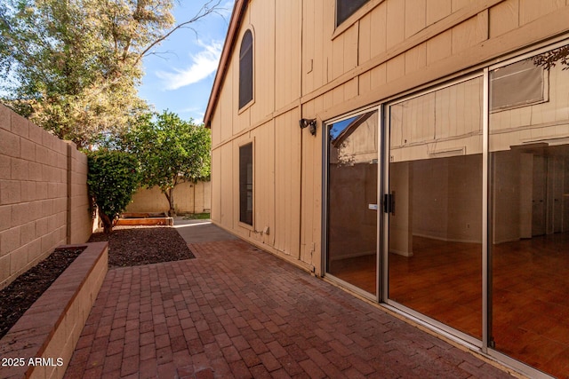 view of side of property with a patio area