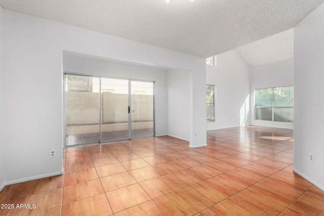 spare room with light tile patterned floors and a textured ceiling