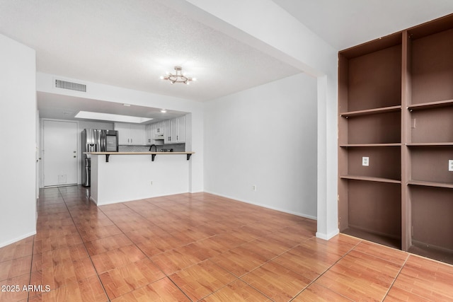 unfurnished living room featuring a textured ceiling