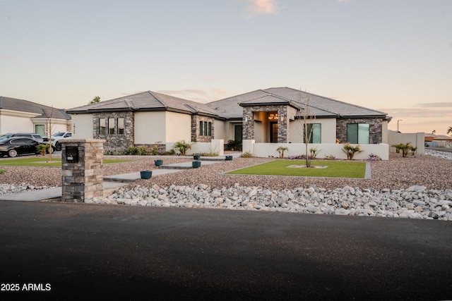 18125 W Montebello Ct Unit 67, Litchfield Park, AZ 85340 - prairie-style home featuring stone siding, stucco siding, and a front lawn