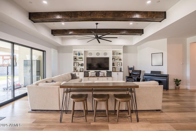 18125 W Montebello Ct Unit 67, Litchfield Park, AZ 85340 - living area featuring light wood-type flooring, ceiling fan, beam ceiling, built in features, and baseboards