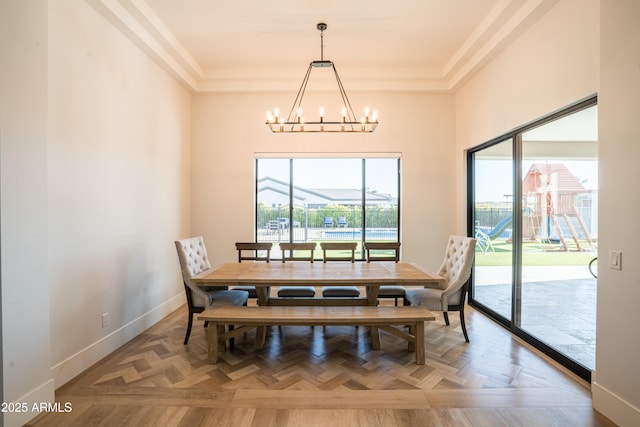 18125 W Montebello Ct Unit 67, Litchfield Park, AZ 85340 - dining area featuring a chandelier, baseboards, a tray ceiling, and ornamental molding