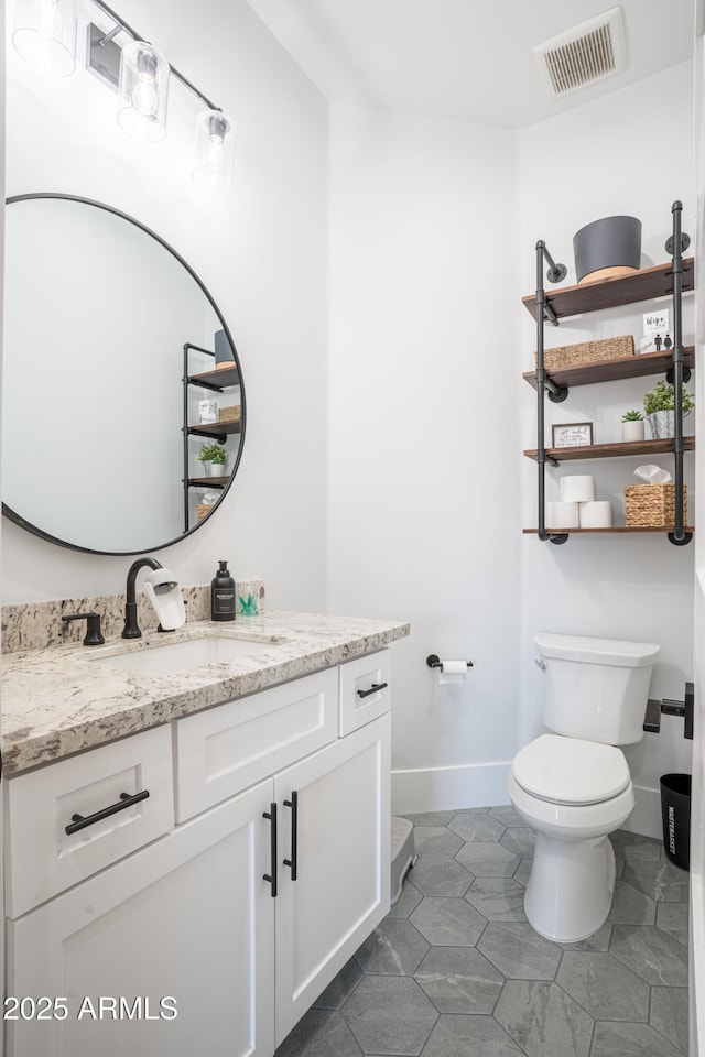 18125 W Montebello Ct Unit 67, Litchfield Park, AZ 85340 - half bathroom with vanity, toilet, baseboards, and tile patterned floors