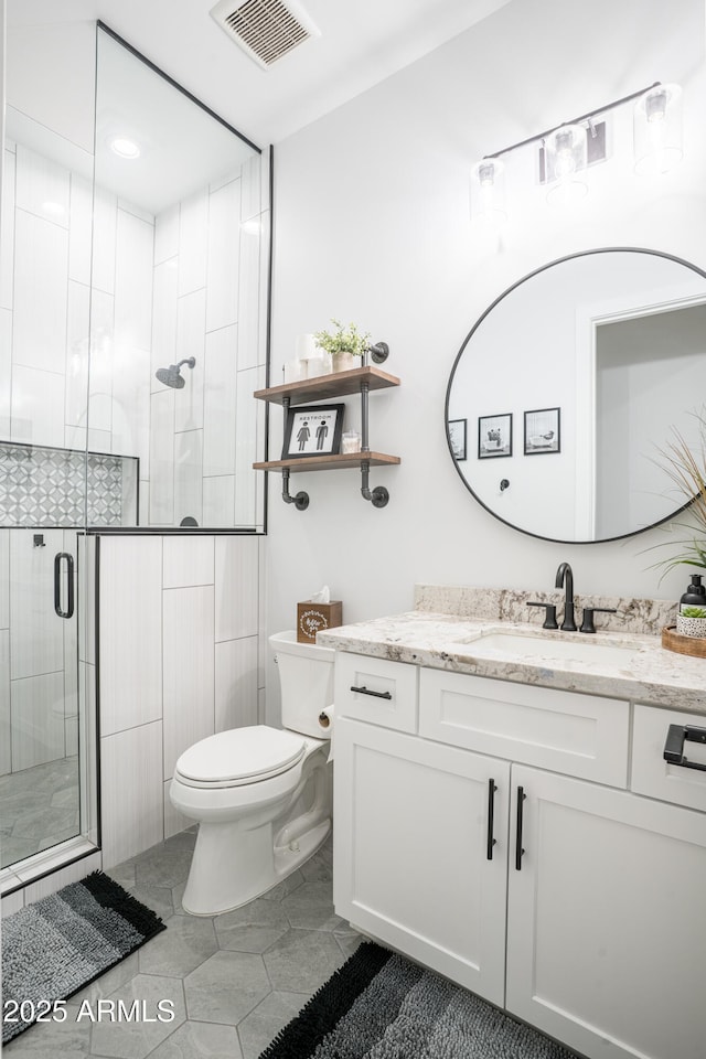 18125 W Montebello Ct Unit 67, Litchfield Park, AZ 85340 - bathroom with vanity, toilet, a shower stall, and tile patterned floors