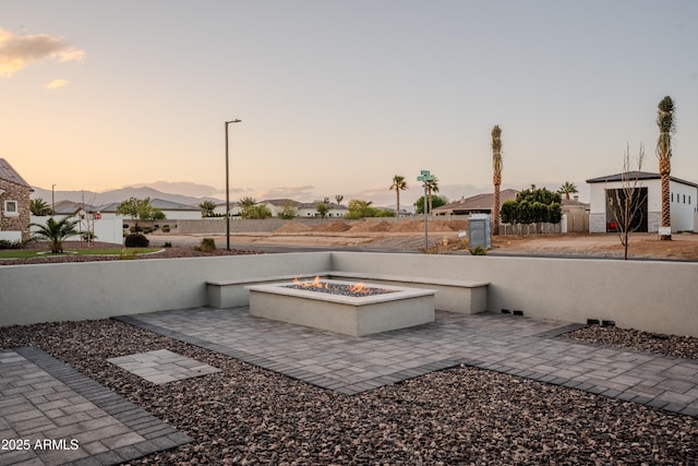 18125 W Montebello Ct Unit 67, Litchfield Park, AZ 85340 - patio terrace at dusk with a fire pit and a patio