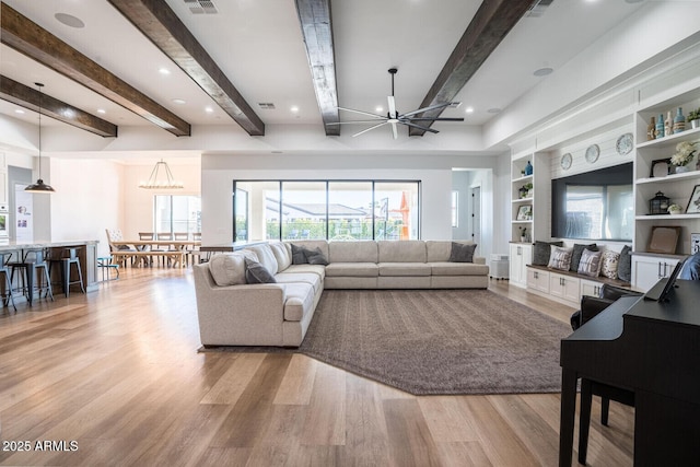 18125 W Montebello Ct Unit 67, Litchfield Park, AZ 85340 - living area featuring light wood-type flooring, beam ceiling, a chandelier, plenty of natural light, and built in features