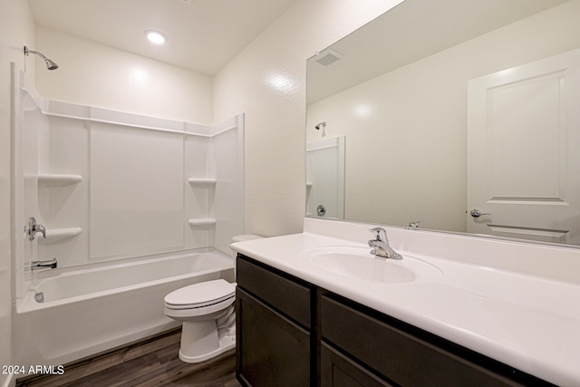 full bathroom with toilet, hardwood / wood-style floors, shower / tub combination, and vanity with extensive cabinet space