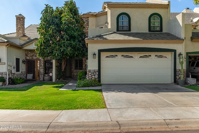 view of front of home featuring a front lawn and a garage