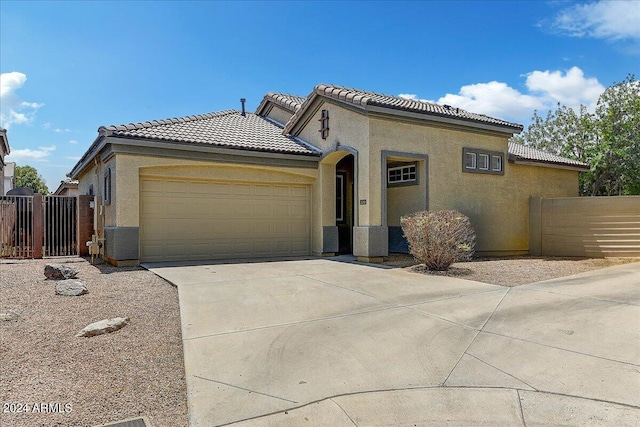 mediterranean / spanish-style home featuring cooling unit and a garage