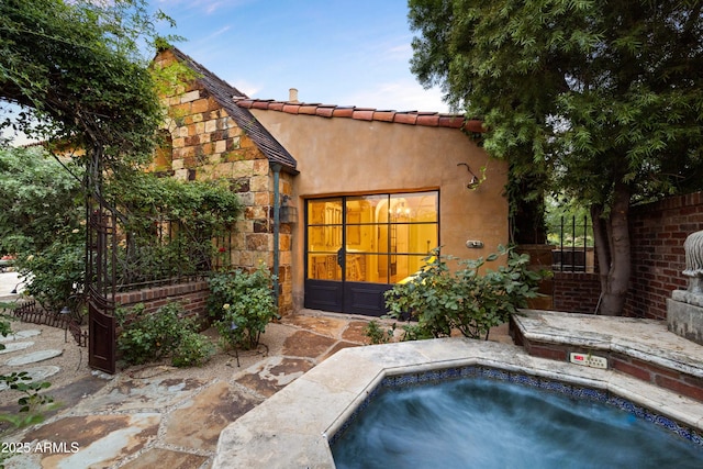 27050 N 103rd St, Scottsdale, AZ 85262 - back of property featuring a hot tub, stucco siding, and stone siding