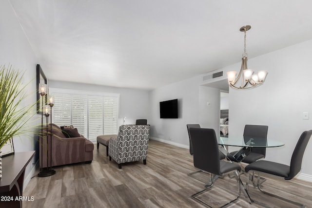 dining area with an inviting chandelier and wood-type flooring