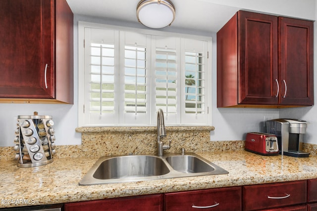 kitchen with sink and light stone counters