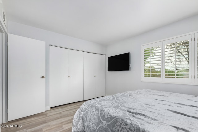 bedroom featuring light hardwood / wood-style flooring and a closet