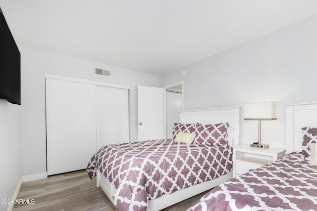 bedroom featuring light hardwood / wood-style floors and a closet