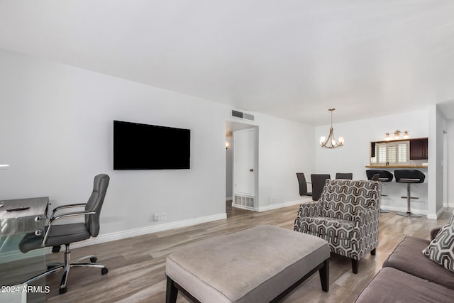 living room featuring a notable chandelier and wood-type flooring