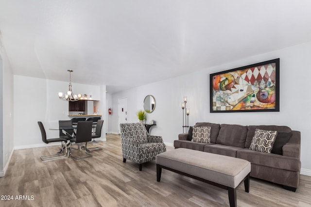 living room with hardwood / wood-style flooring and a notable chandelier