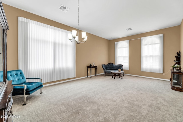 living area featuring a chandelier, carpet, visible vents, and baseboards