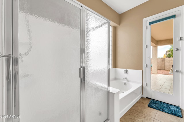 full bath with a shower stall, a bath, and tile patterned floors