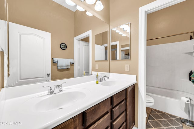 full bathroom featuring toilet, double vanity, a sink, and shower / bathing tub combination