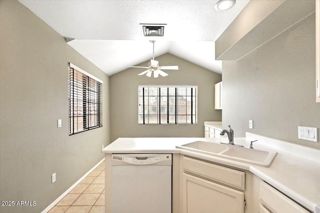 kitchen featuring light tile patterned flooring, lofted ceiling, sink, dishwasher, and kitchen peninsula