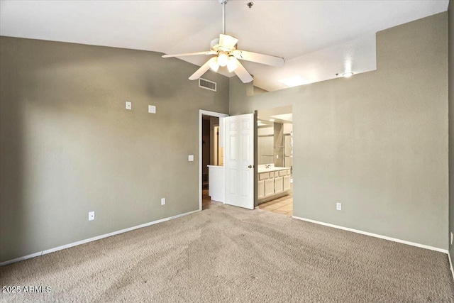 unfurnished bedroom featuring lofted ceiling, light carpet, ceiling fan, and ensuite bathroom