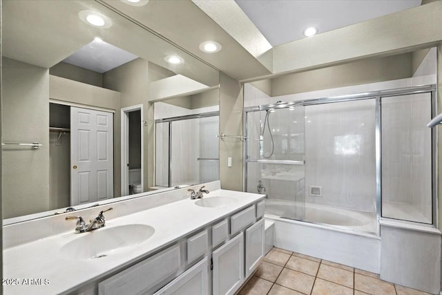 full bathroom with tile patterned flooring, vanity, bath / shower combo with glass door, and toilet