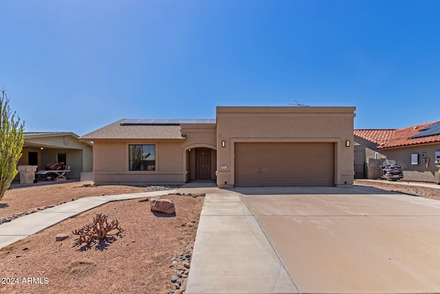 view of front facade featuring solar panels and a garage