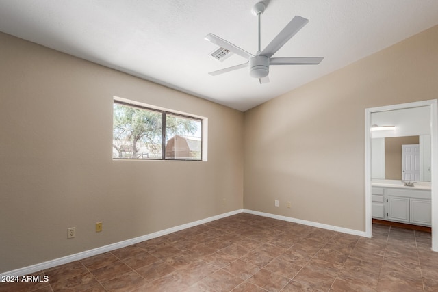 unfurnished bedroom featuring ensuite bath and ceiling fan